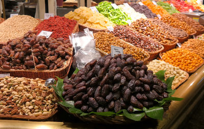 Dried fruits in baskets at market for sale