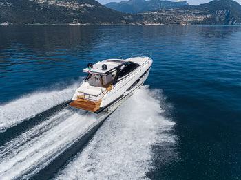 Nautical vessel on sea against mountain