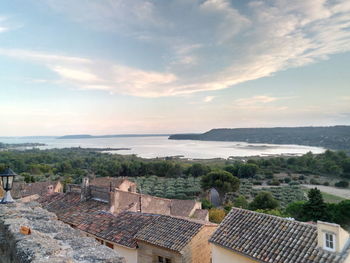 High angle view of buildings by sea against sky