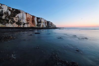 Scenic view of sea against clear sky at sunset