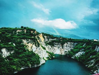 Scenic view of waterfall against sky