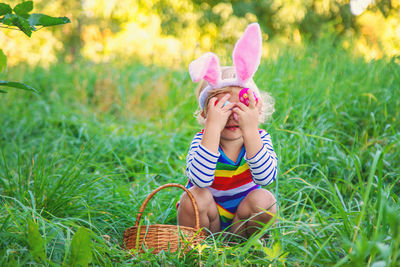 Rear view of woman holding potted plant