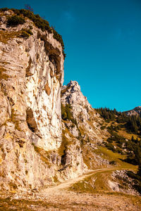 Rock formations on landscape against blue sky