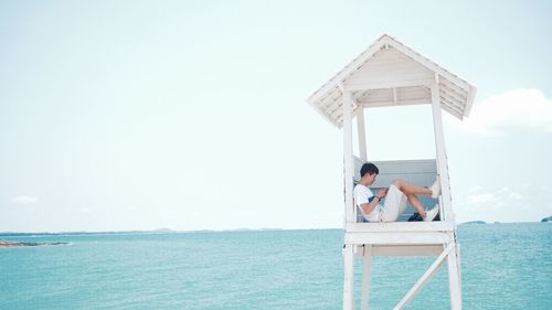 Lifeguard relaxing by sea