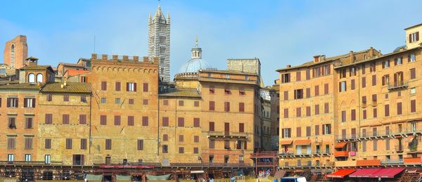 Historical buildings at piazza del campo against sky