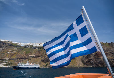 Scenic view of flag on mountain against sky