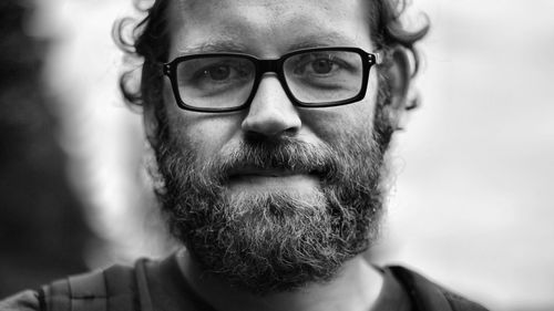 Close-up portrait of mid adult man wearing eyeglasses