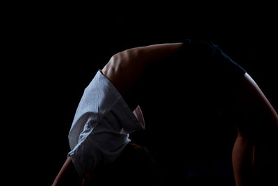 Woman wearing hat against black background