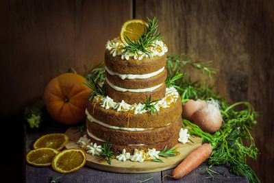 Cake on wooden table against wall