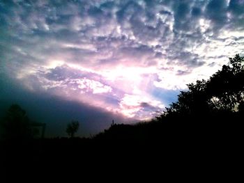 Silhouette of landscape against cloudy sky