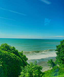 Scenic view of sea against blue sky