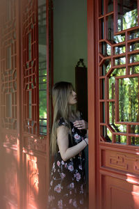 Woman standing on doorway