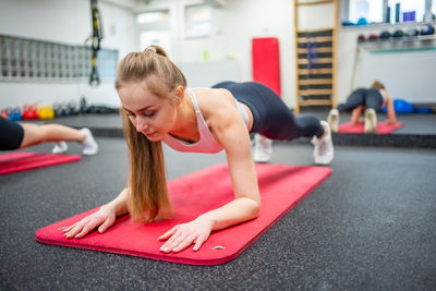 Young woman exercising in gym