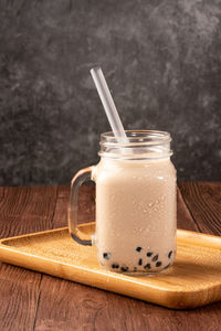 Close-up of drink in glass jar on table