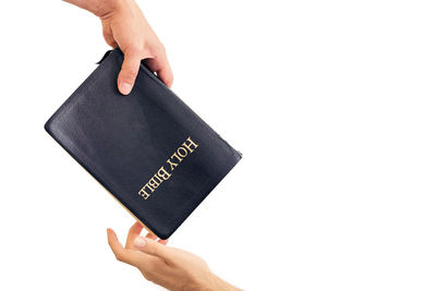 Low angle view of person holding hands against white background