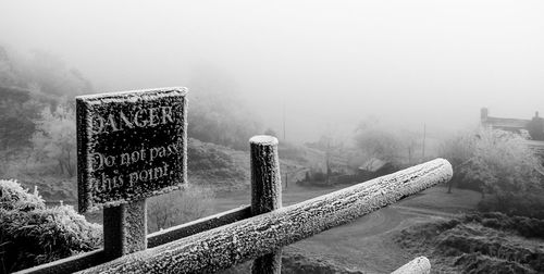 Text on snow against sky during winter