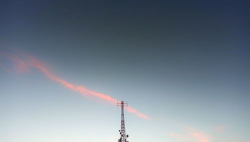 Low angle view of smoke emitting from chimney against sky