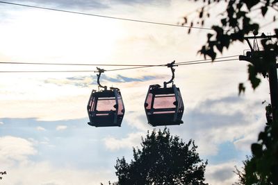 Low angle view of overhead cable car against sky