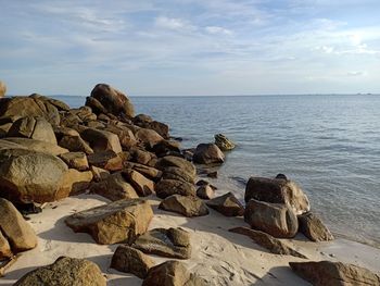 Rocks on beach against sky