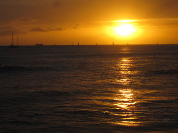 Scenic view of sea against orange sky