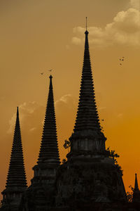 Low angle view of pagoda against sky during sunset