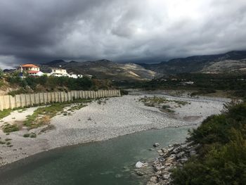 Scenic view of lake against storm clouds