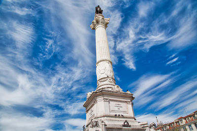 Low angle view of statue against blue sky