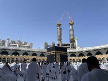 People in front of cathedral against clear sky