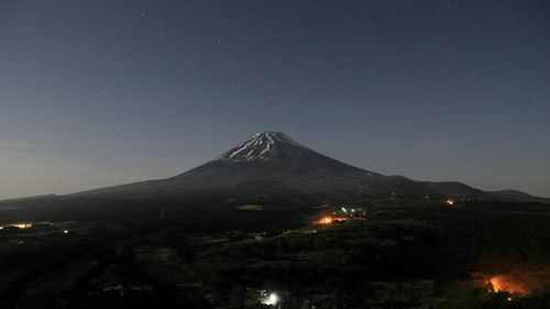 Scenic view of landscape against sky at night