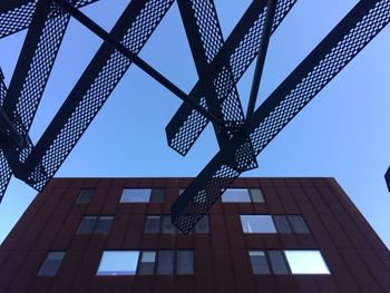 Low angle view of buildings against clear blue sky