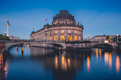 View of bridge over river at night