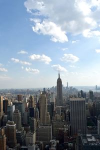 View of cityscape against cloudy sky