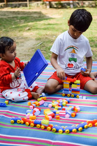 Two happy boys in society park, happy asian brothers who are smiling happily together. brothers play