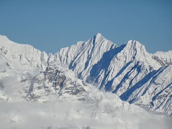 Scenic view of snowcapped mountains against clear sky