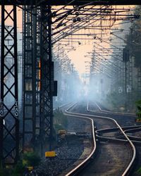 Railroad tracks by electricity pylons