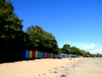 Multi colored chairs on beach against clear blue sky