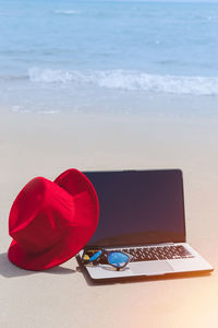 Red and book on table at beach