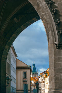 Low angle view of arch bridge against buildings