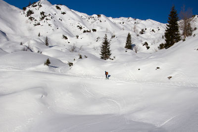 People skiing on snow covered mountain