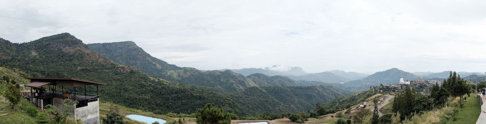 Panoramic shot of buildings and mountains against sky