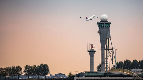 Airplane taking off with atc tower in foreground