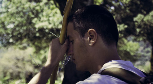 Close-up of man against tree