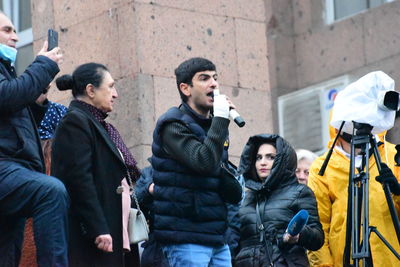 People standing on street in city