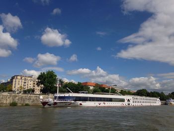 Boats in river against sky