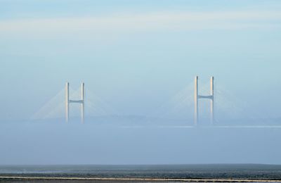 Bridge over sea against sky