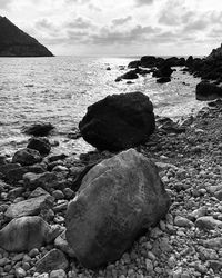 Rocks on beach against sky