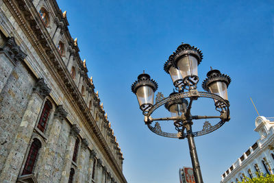 Low angle view of street light against building