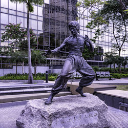 Statue against trees in city