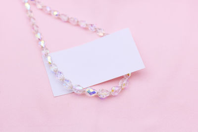 High angle view of heart shape decoration on pink background