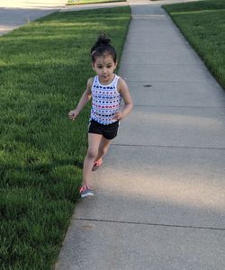 Girl running on footpath in park